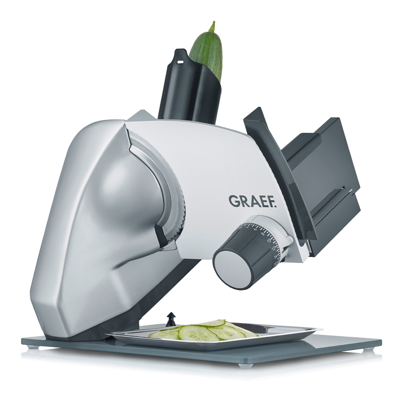 Trancheuse de légumes avec concombre et tranches de concombre sur plateau