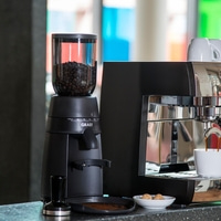 Coffee machine with grinder and accessories, coffee beans and espresso