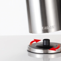 Stainless steel kettle with rotating base and GRAEF logo, close-up
