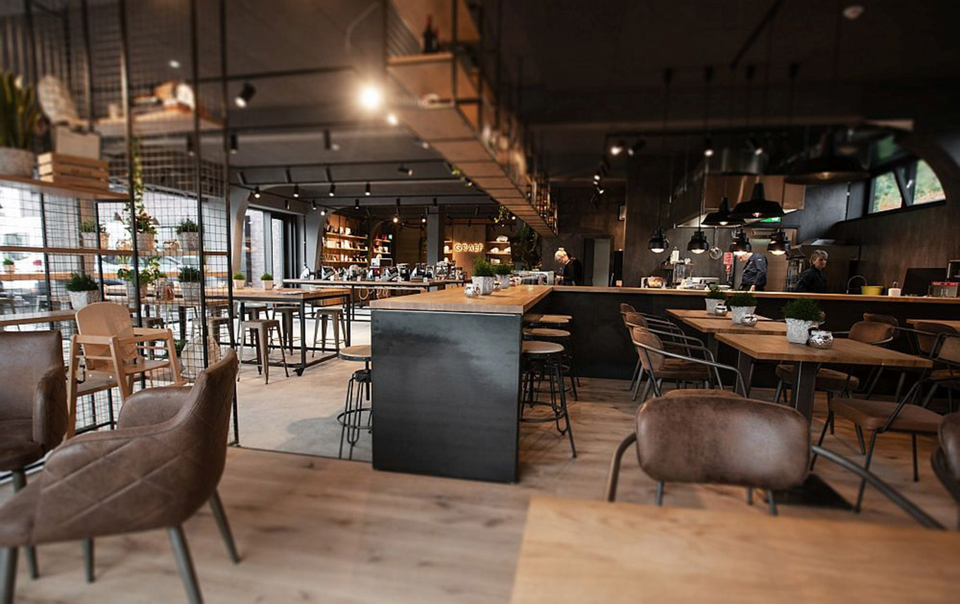 Interior of a cafe with tables, chairs, and a bar