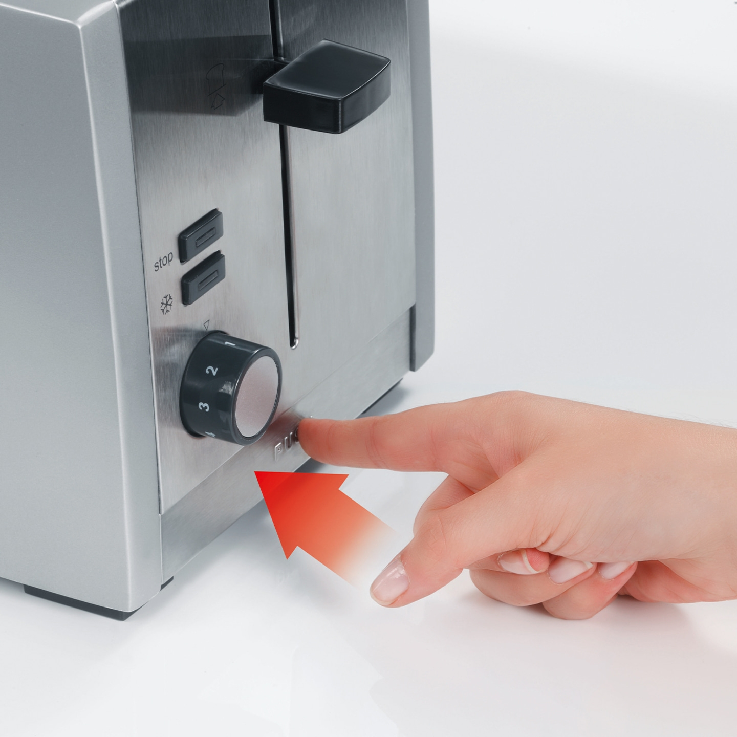 Hand pressing button on toaster, arrow pointing direction, close-up, appliance