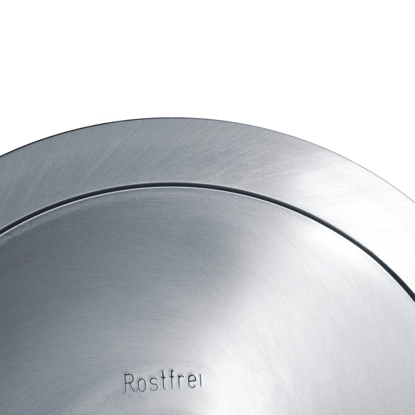 Gros plan d'une surface métallique argentée avec le mot Rostfrei gravé.
