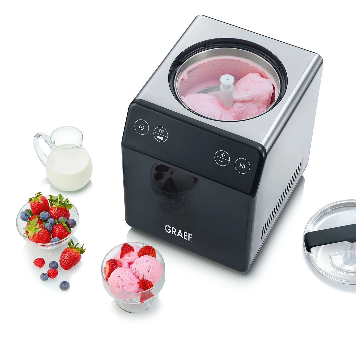 Ice cream maker with ice cream, berries and milk. Preparing delicious dessert.
