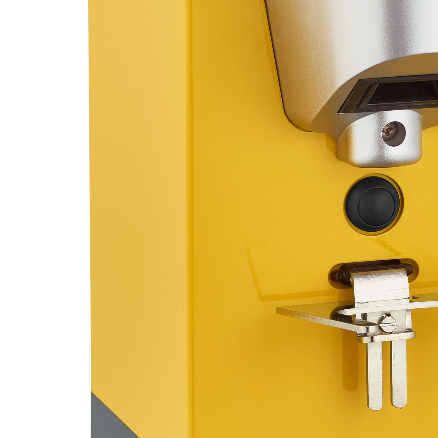 Yellow machine with button and metal part, close-up, detail shot