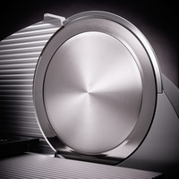 Close-up of a silver slicer with a shiny surface and shadows, modern design