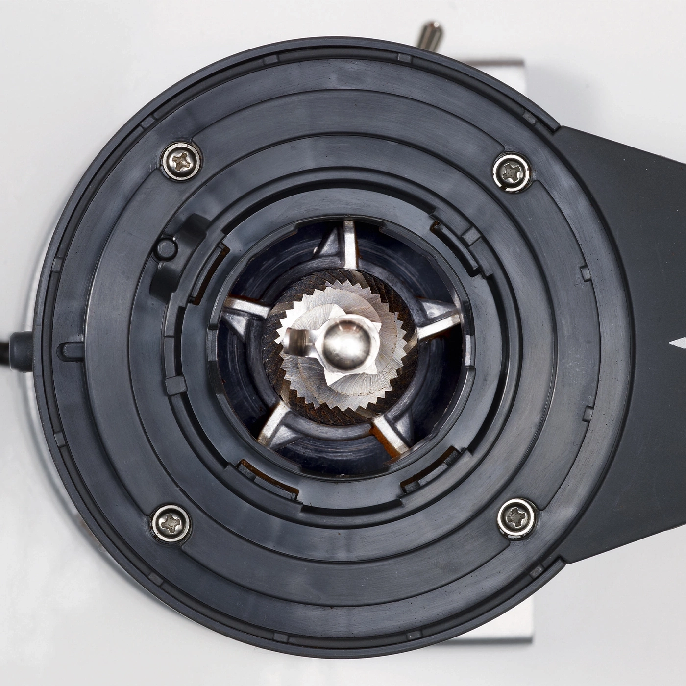 Coffee grinder, close-up, black casing, screws, grinding mechanism, internal parts.