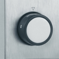 Knob with numbers and a triangle on a metallic surface, close-up shot