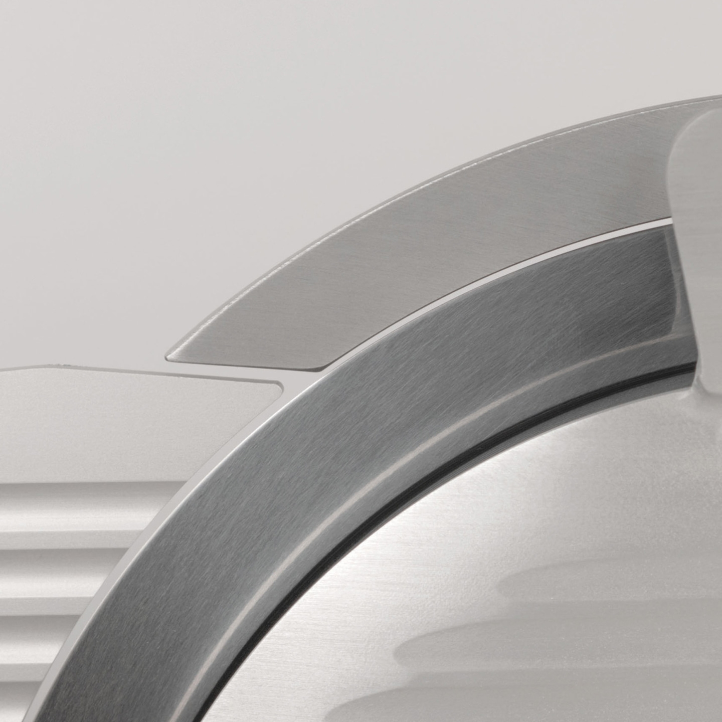 Close-up of a silver kitchen appliance with curved blade and intricate details