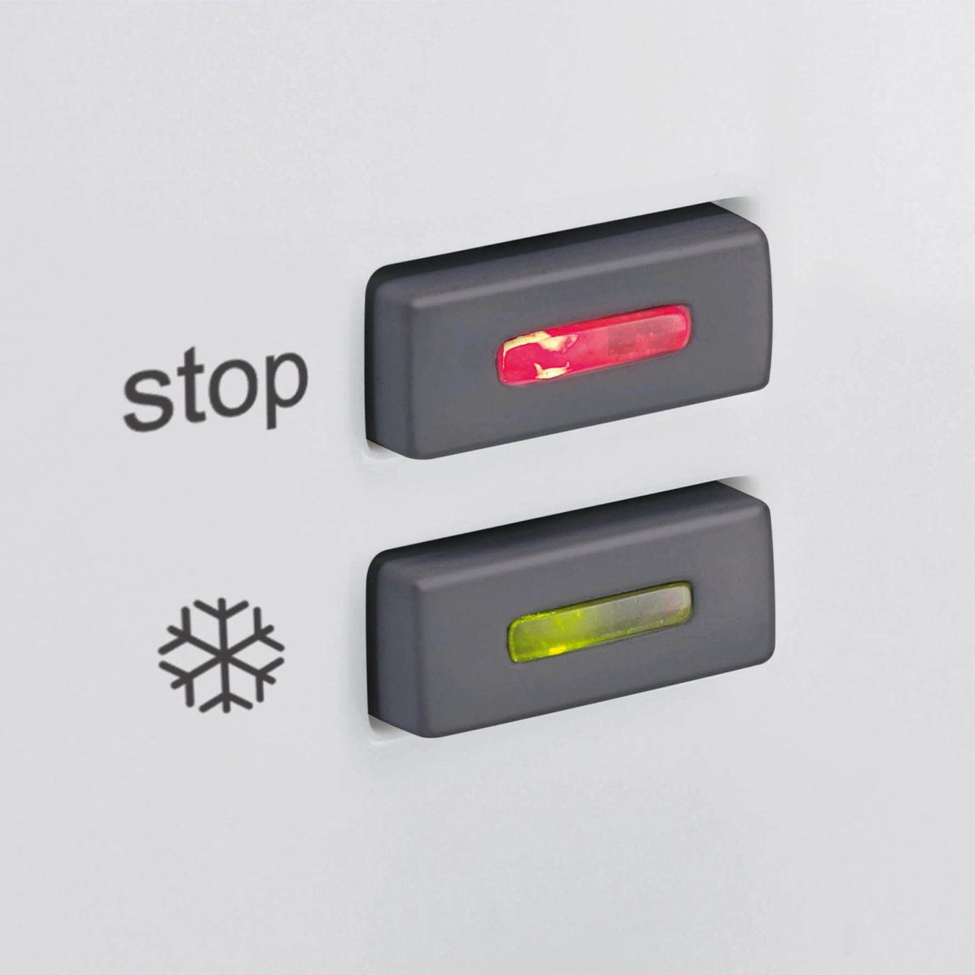 Refrigerator control panel with red and green indicators, stop button, and snowflake symbol.