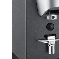 Close-up of a black device with a button and a metal part