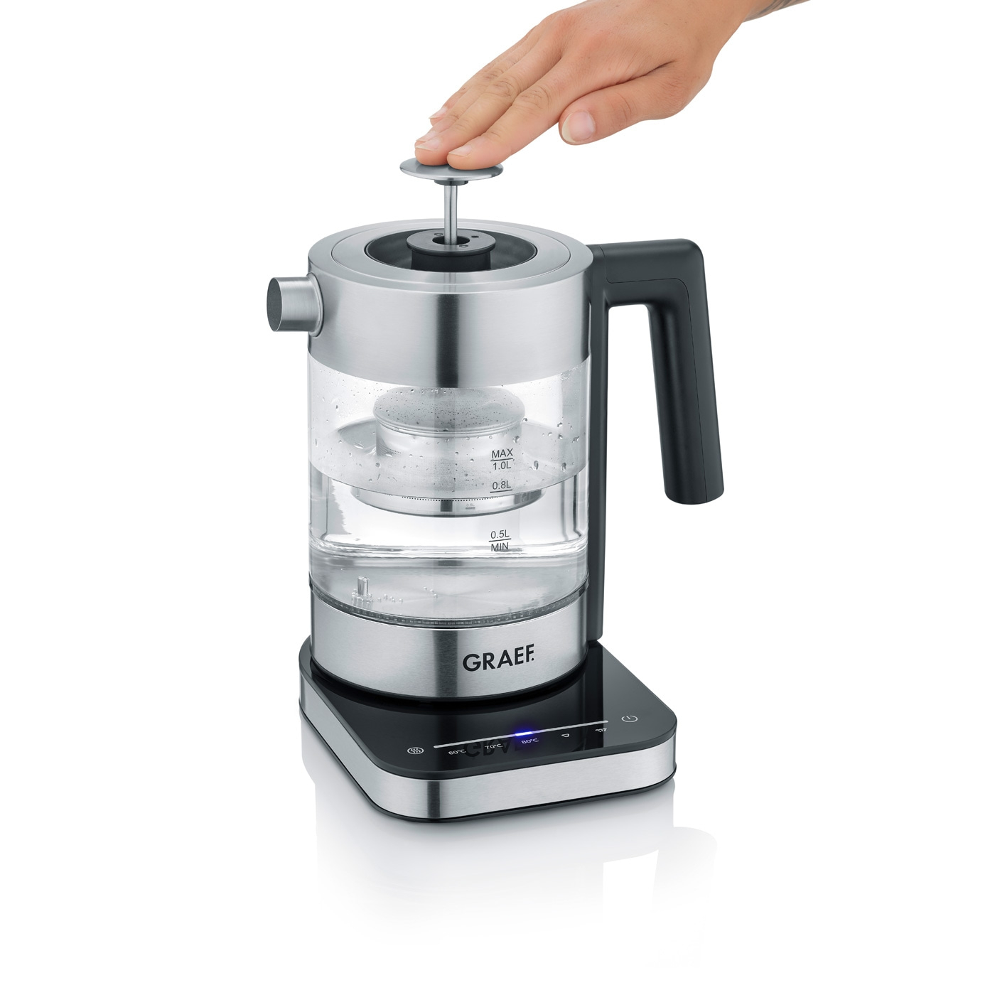 Kettle with hand opening the lid, GRAEF logo, and temperature display on a black base.