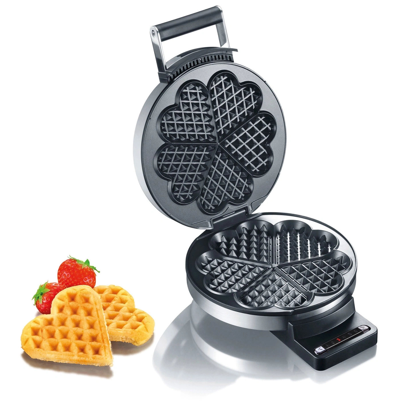 Heart-shaped waffle iron with waffles and strawberries, open, close-up shot