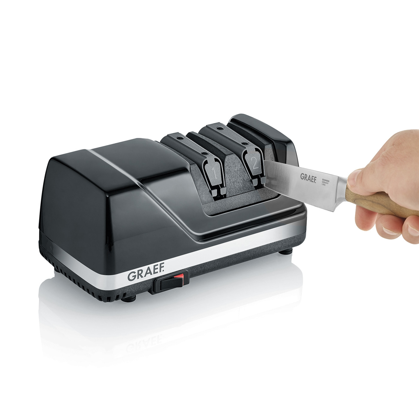 Affilacoltelli elettrico nero con coltello e mano, marchio GRAEF.