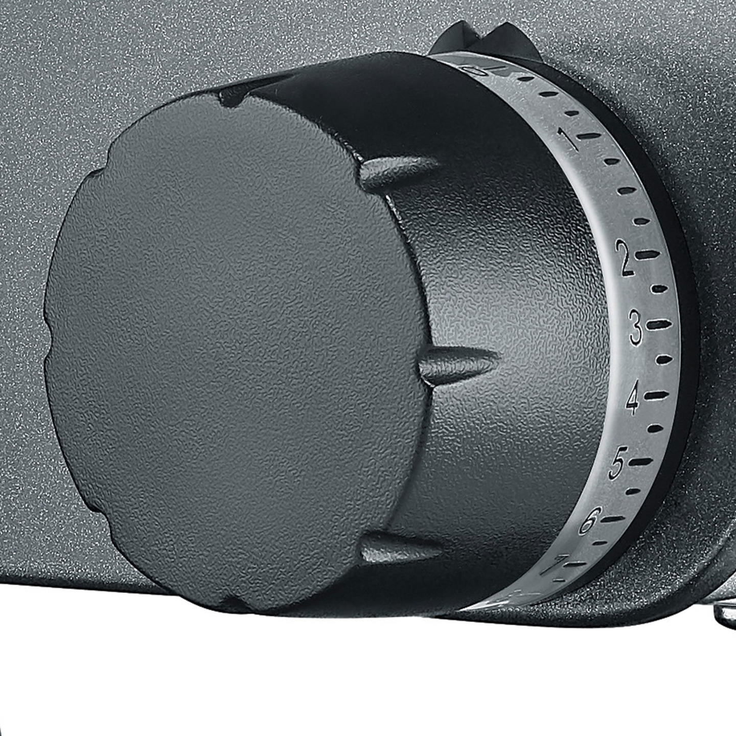 Close-up of a black dial with numbers on a silver ring, detailed shot.