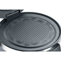 Close-up of a waffle iron with waffle grid and decorative border
