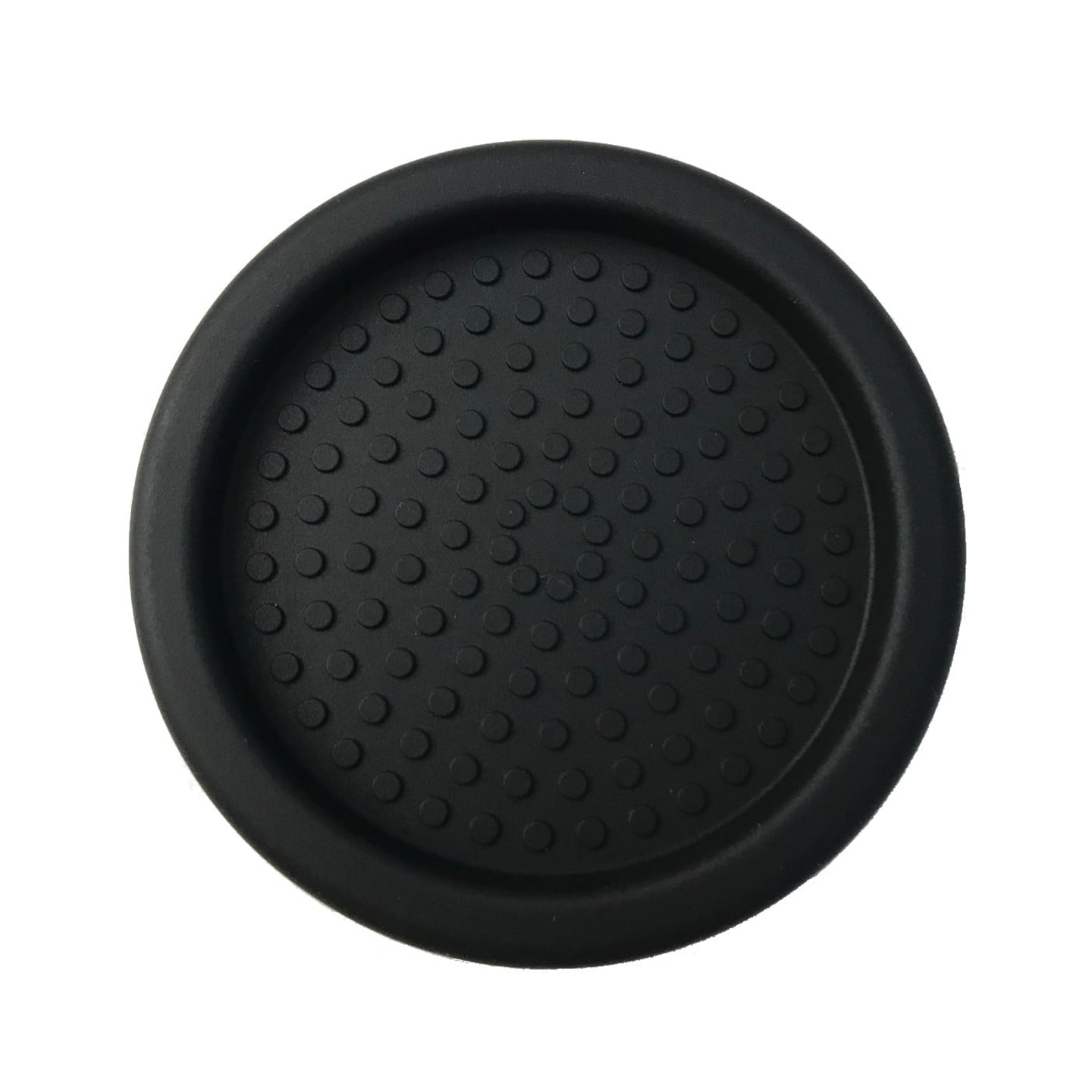Black drink coaster with circular indentations, close-up detail, isolated object