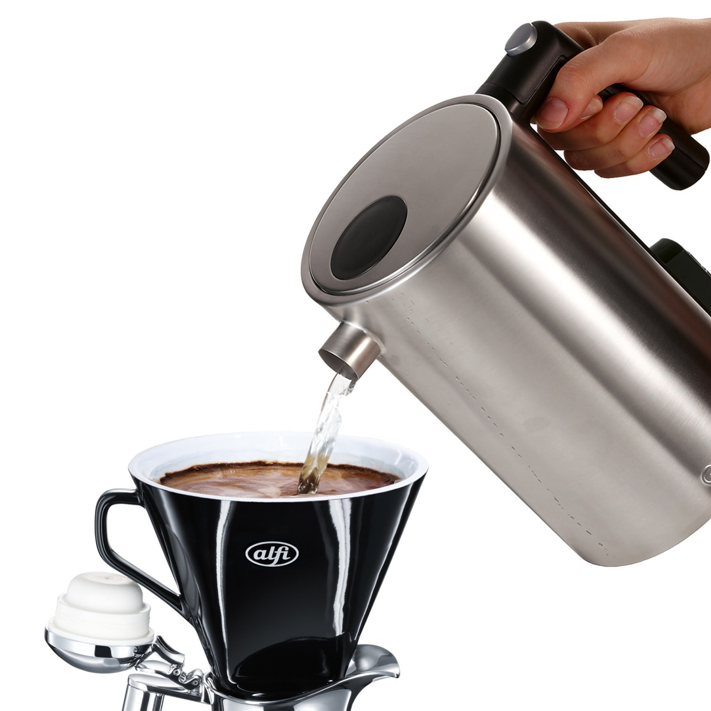 Kettle pouring water into a black coffee cup with a coffee filter.