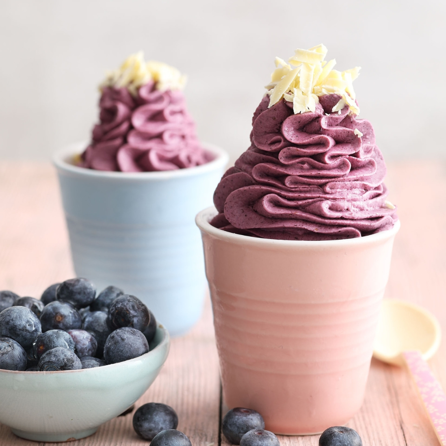 Blueberry desserts in cups with white chocolate and blueberries