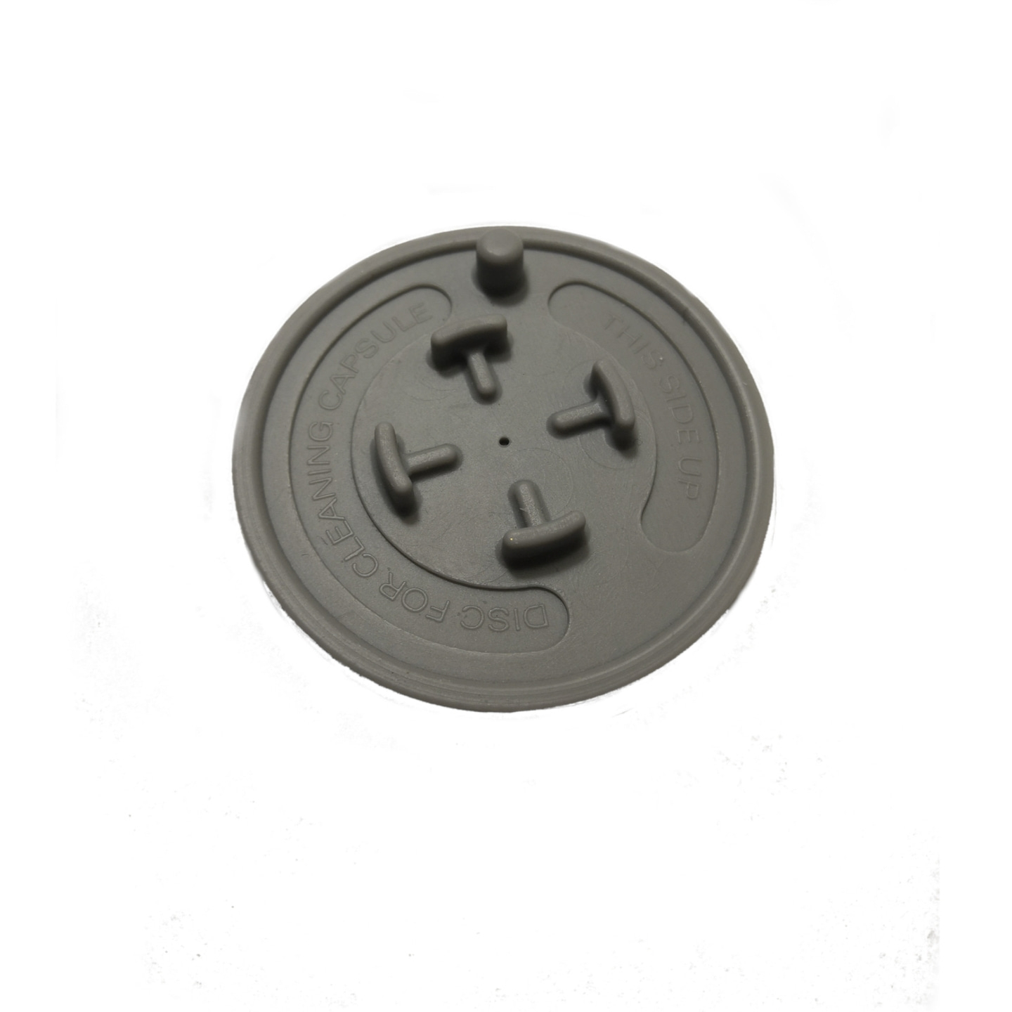 Disque gris avec texte 'DISC FOR CLEANING CAPSULE' et 'THIS SIDE UP'.