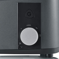 Close-up of a device with a dial and logo. Black and gray color scheme.