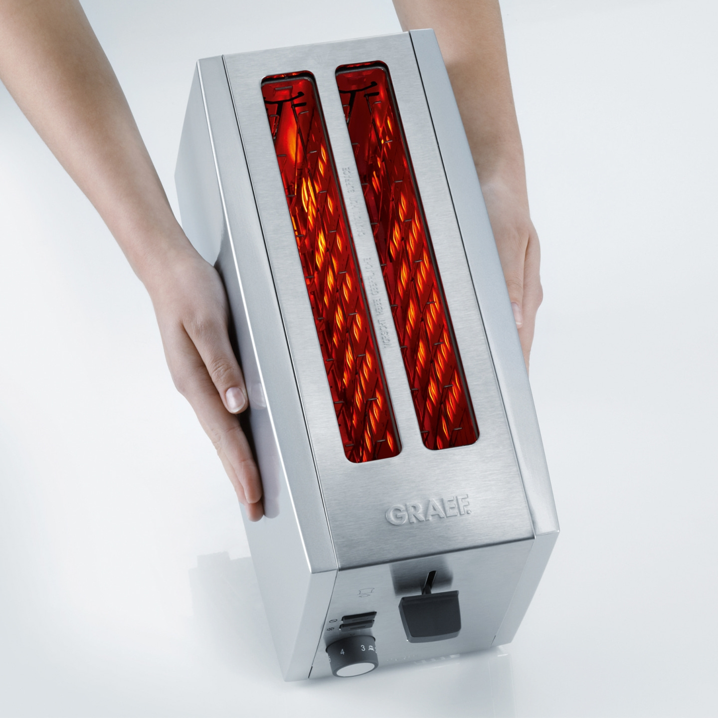 Toaster held by hands, stainless steel, GRAEF, toasting, kitchen, appliance, warm