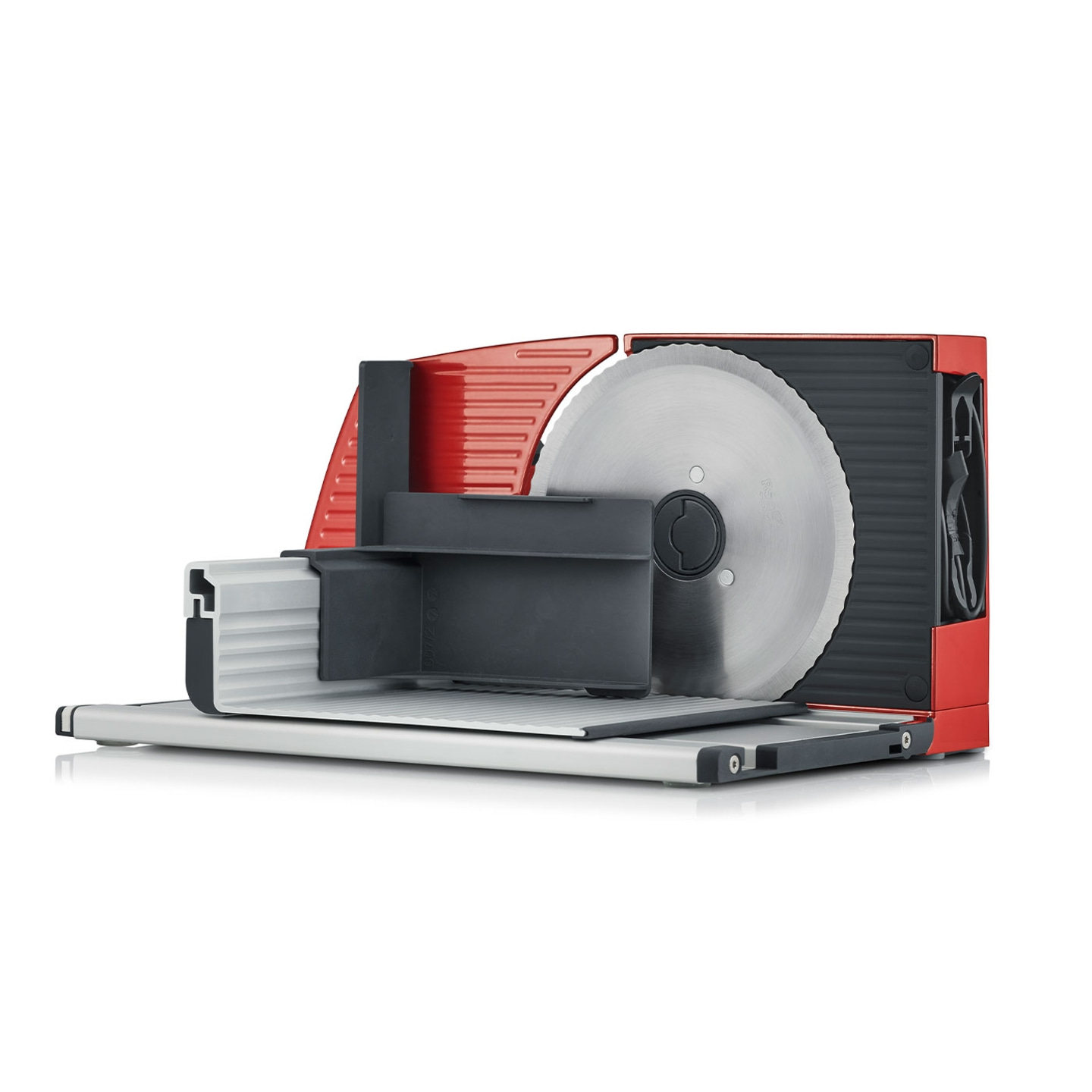 Red electric slicer with large circular blade and black housing, isolated